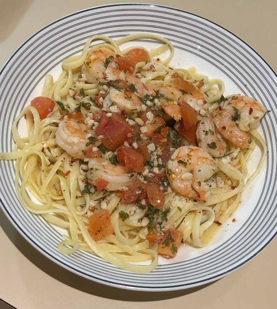 picture of shrimp baked in olive oil with chopped garlic and crushed red pepper