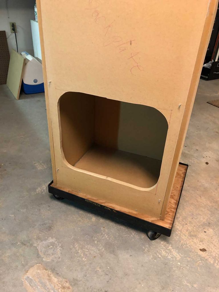 Interior wiring and hardware placement inside the garage arcade build