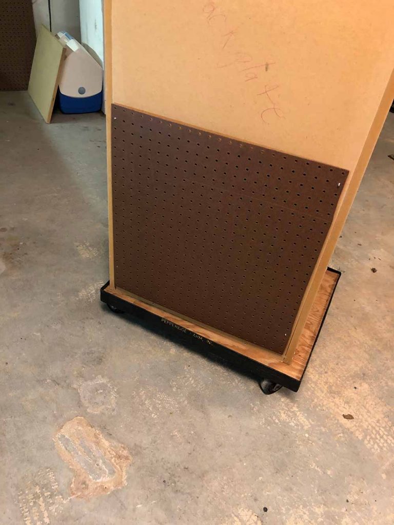 Pegboard rear cover installed for airflow and dust control